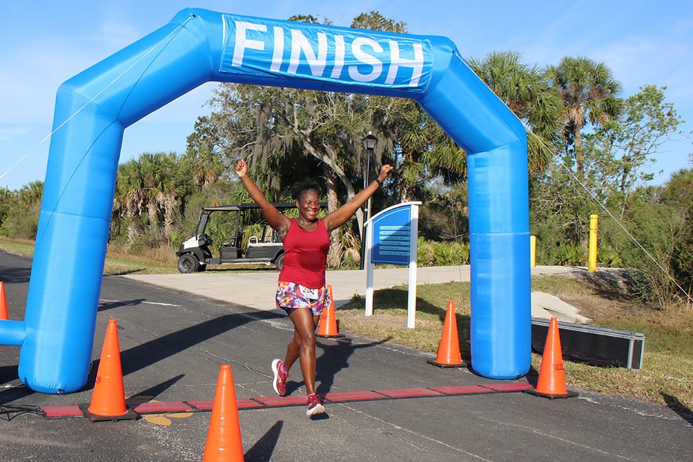 Photo of happy woman finishing the race.