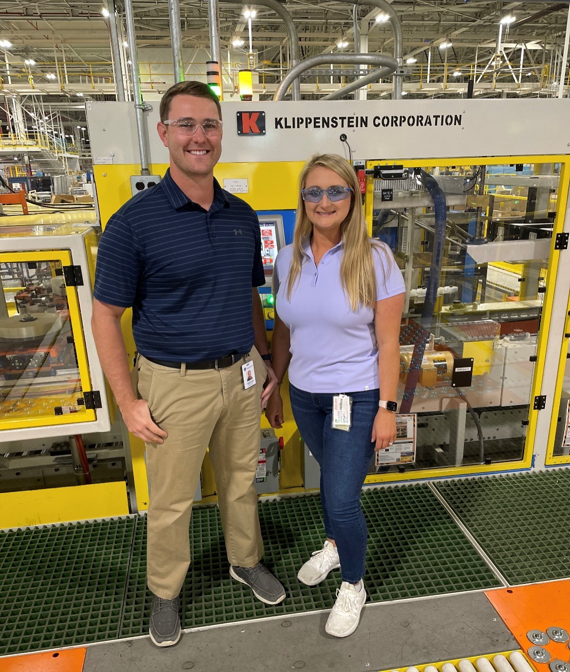 man and woman smile in production plant